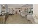 Open-concept living space with tile floors, modern furniture, and a seamless flow to the kitchen and dining area at 10788 Tarflower Dr # 201, Venice, FL 34293