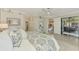 Bedroom with a full bed and access to a screened balcony at 10788 Tarflower Dr # 201, Venice, FL 34293