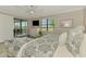 Lake view bedroom with a large window, and access to a screened balcony at 10788 Tarflower Dr # 201, Venice, FL 34293