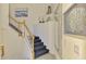 Elegant staircase featuring carpeted steps, white wood banisters and coordinated decor and wall art at 10788 Tarflower Dr # 201, Venice, FL 34293