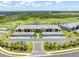 An aerial view reveals a lush community with serene ponds, manicured golf courses, and upscale condo living at 12470 Wellen Golf St # 107, Venice, FL 34293