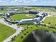 Aerial view of the Atlanta Braves CoolToday Park stadium, including the field, parking and surrounding landscape at 12470 Wellen Golf St # 107, Venice, FL 34293