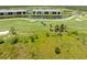Aerial view of a golf course and pond, where the golf course and associated real estate is located at 12470 Wellen Golf St # 107, Venice, FL 34293