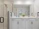Modern bathroom with double vanity, sleek fixtures, and a walk-in shower at 12470 Wellen Golf St # 107, Venice, FL 34293