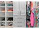 Organized walk-in closet with custom shelving and clothing racks at 12470 Wellen Golf St # 107, Venice, FL 34293