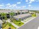 Condo building exterior featuring tile roof, attached garages and mature palm tree landscaping at 12470 Wellen Golf St # 107, Venice, FL 34293