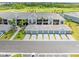 A view of a unit complex from above showing garages, landscaping, and proximity to golfing at 12470 Wellen Golf St # 107, Venice, FL 34293