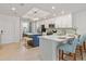 Modern kitchen with white cabinets, breakfast bar, stainless appliances, and island at 12470 Wellen Golf St # 107, Venice, FL 34293