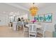 Bright, open kitchen and dining area featuring modern lighting and a fresh, inviting design at 12470 Wellen Golf St # 107, Venice, FL 34293