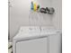 Efficient laundry area with modern white washer and dryer units at 12470 Wellen Golf St # 107, Venice, FL 34293