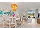 Open living area with elegant lighting, comfortable seating, and views of the lush outdoors at 12470 Wellen Golf St # 107, Venice, FL 34293