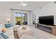 Inviting living room featuring modern furnishings, a cozy fireplace, and serene outdoor views at 12470 Wellen Golf St # 107, Venice, FL 34293