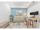 Comfortable home office featuring a modern desk, stylish rug, and sofa at 12470 Wellen Golf St # 107, Venice, FL 34293