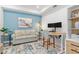 Comfortable home office featuring a modern desk, stylish rug, and sofa at 12470 Wellen Golf St # 107, Venice, FL 34293