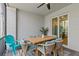 Patio with a dining table, chairs, a ceiling fan, and a sliding glass door at 12470 Wellen Golf St # 107, Venice, FL 34293