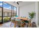 Screened patio with dining table, chairs, outdoor rug and view of nearby walkway at 12470 Wellen Golf St # 107, Venice, FL 34293
