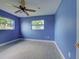 A spacious bedroom features two windows that let in an abundance of natural light, plus a ceiling fan at 1295 S Maryknoll Rd, Englewood, FL 34223