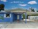 Exterior shot of the house carport featuring support pillars, white trim and the house number at 1295 S Maryknoll Rd, Englewood, FL 34223