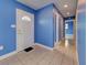 Home entryway showing tiled floor, a front door, and hallways into other rooms at 1295 S Maryknoll Rd, Englewood, FL 34223