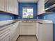 White cabinetry with granite countertops provide style and practical workspace at 1295 S Maryknoll Rd, Englewood, FL 34223