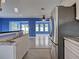 Open kitchen with stainless steel appliances flows into a living area with ample natural light at 1295 S Maryknoll Rd, Englewood, FL 34223