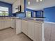 Bright kitchen area with ample counter space and white cabinetry, flowing into the adjacent living area at 1295 S Maryknoll Rd, Englewood, FL 34223