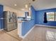 Well-equipped kitchen featuring stainless steel refrigerator and a seamless flow into the living area at 1295 S Maryknoll Rd, Englewood, FL 34223