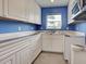 Well-lit kitchen showcasing white cabinets and granite countertops, enhancing the cooking experience at 1295 S Maryknoll Rd, Englewood, FL 34223