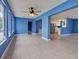 Spacious living area with tile flooring, bright blue walls, and an open kitchen concept at 1295 S Maryknoll Rd, Englewood, FL 34223