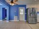 View of an open living area with tile floors, easy access to the kitchen, and a backyard door at 1295 S Maryknoll Rd, Englewood, FL 34223