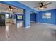 Open-concept living area with tile flooring, ceiling fans, and easy access to the modern kitchen at 1295 S Maryknoll Rd, Englewood, FL 34223
