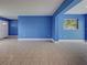 Open-concept living area with tiled floors, neutral walls, and ample natural light at 1295 S Maryknoll Rd, Englewood, FL 34223