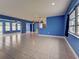 Expansive living area showcasing tile flooring and natural light, flowing seamlessly into additional living spaces at 1295 S Maryknoll Rd, Englewood, FL 34223