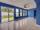 Living room with tile flooring, lots of light and glass doors leading to an outdoor space at 1295 S Maryknoll Rd, Englewood, FL 34223