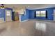 Bright living room with tile floors and a kitchen with stainless steel appliances and access to the outside at 1295 S Maryknoll Rd, Englewood, FL 34223