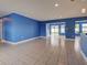 Open-concept living space with tile flooring and natural light, seamlessly connecting to the outdoor area at 1295 S Maryknoll Rd, Englewood, FL 34223