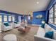 Stylishly furnished living room with ample seating and a view into the dining and kitchen areas at 1295 S Maryknoll Rd, Englewood, FL 34223