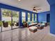 Cozy living room with neutral colored furniture, tile floors, and glass doors leading to outdoor space at 1295 S Maryknoll Rd, Englewood, FL 34223