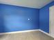 Bright room with light tile floors, blue walls, and a white door at 1295 S Maryknoll Rd, Englewood, FL 34223