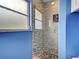 Updated glass enclosed shower features decorative mosaic tiling and a rain shower head at 1295 S Maryknoll Rd, Englewood, FL 34223