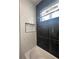 Stylish bathroom with a tub, shower featuring black and white tiling, and built-in shower niches at 14149 Whittier Ln, Port Charlotte, FL 33981