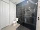 Elegant bathroom showcasing a black marble shower with modern fixtures and a tiled floor at 14149 Whittier Ln, Port Charlotte, FL 33981