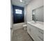 Modern bathroom with tub and shower featuring black and white tiling, and vanity at 14149 Whittier Ln, Port Charlotte, FL 33981