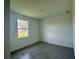 Bedroom featuring a window for natural light and wood-look tile flooring at 14149 Whittier Ln, Port Charlotte, FL 33981