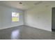 Bright bedroom with a window and neutral-toned, wood-look tile flooring at 14149 Whittier Ln, Port Charlotte, FL 33981