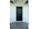 A welcoming front entrance with a stylish black door and tiled porch at 14149 Whittier Ln, Port Charlotte, FL 33981