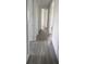 Hallway with wood-look tile flooring and multiple doorways at 14149 Whittier Ln, Port Charlotte, FL 33981