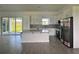 Bright kitchen featuring white cabinetry, stainless steel appliances, an island with quartz countertops, and patterned backsplash at 14149 Whittier Ln, Port Charlotte, FL 33981