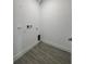 A compact laundry room with connections and tiled flooring, ready for appliances at 14149 Whittier Ln, Port Charlotte, FL 33981