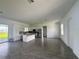 Spacious living room with grey tile floors, white walls, and abundant natural light at 14149 Whittier Ln, Port Charlotte, FL 33981
